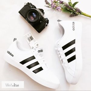 black adidas sneakers with white stripes